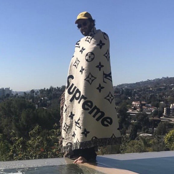 Lil Mayo spotted on Louis Vuitton & Supreme collaborative blanket